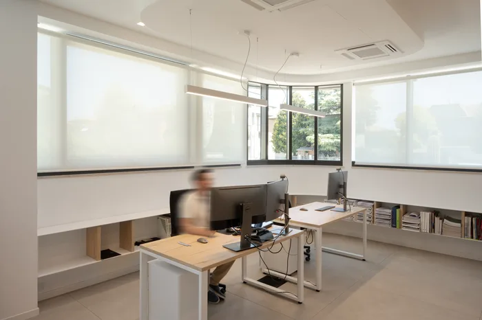 Ufficio dello showroom Bisacchi con postazioni di lavoro e tende a rullo